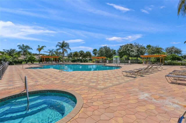8956 Stone Harbour Loop, Bradenton, FL 34212 - pool with a patio, a hot tub, fence, and a pergola