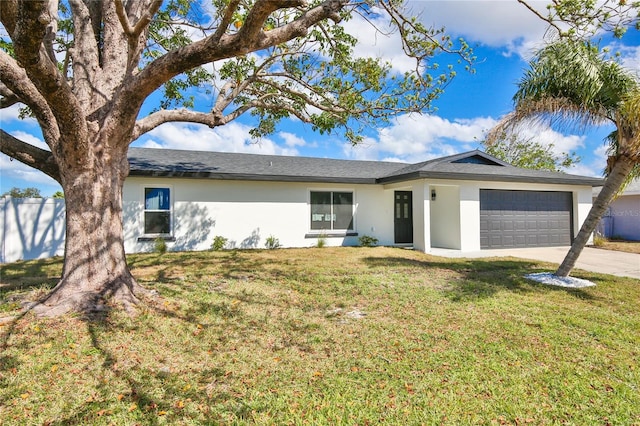 ranch-style house featuring a garage and a front lawn