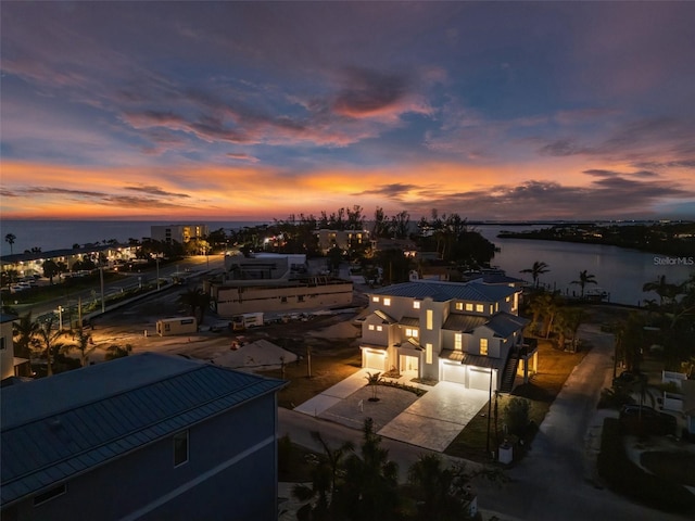 aerial view at dusk with a water view