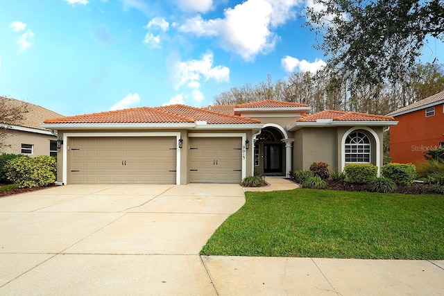 mediterranean / spanish-style house with a garage and a front yard