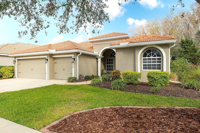 mediterranean / spanish-style home with a garage and a front yard