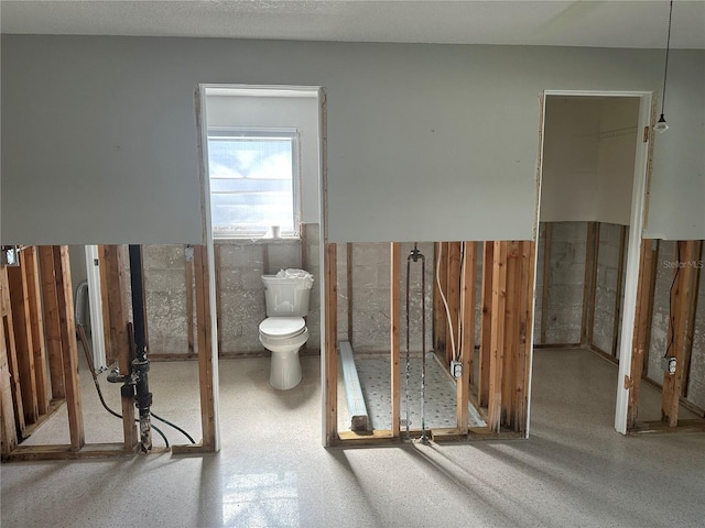 bathroom featuring a wainscoted wall and toilet