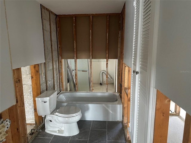 full bathroom with a bathtub, tile patterned flooring, and toilet