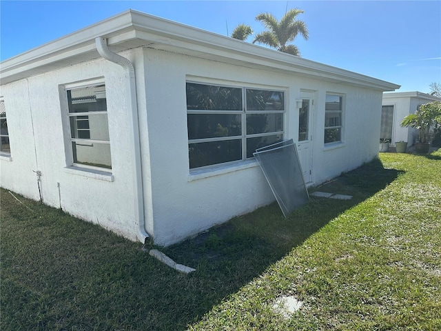 view of home's exterior featuring a yard and stucco siding