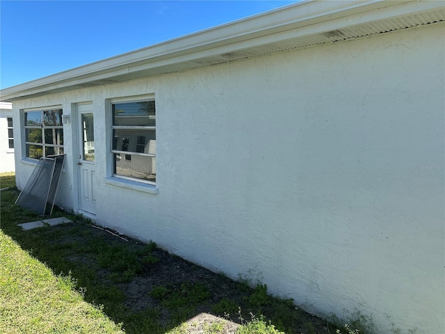 view of side of home featuring stucco siding