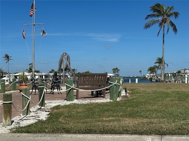 view of community with a water view and a yard