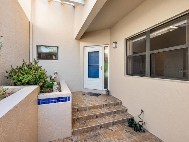 property entrance with stucco siding