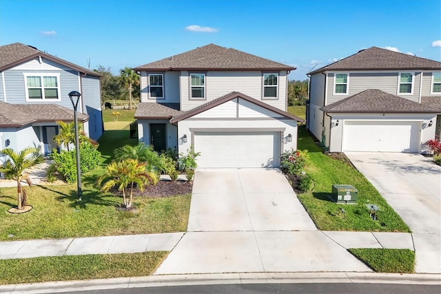 view of property featuring a garage and a front yard