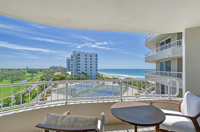 balcony featuring a water view and a view of the beach