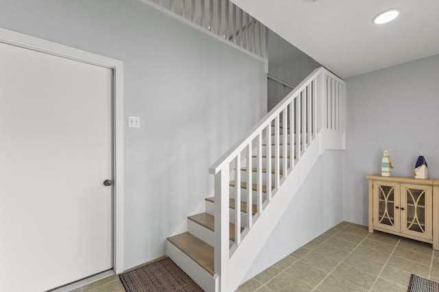 stairs featuring tile patterned floors and recessed lighting