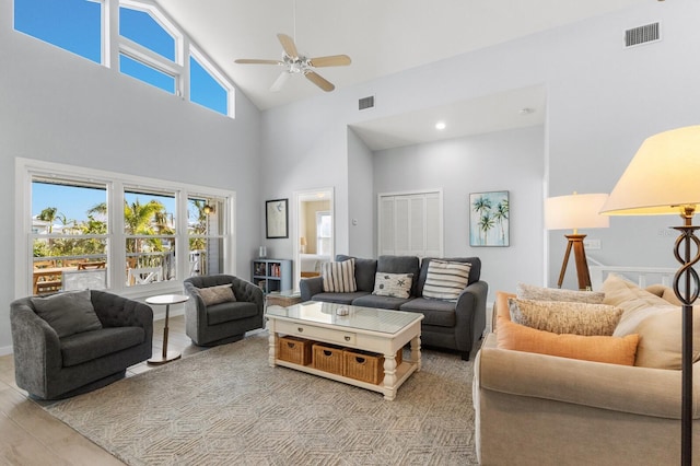 living room featuring high vaulted ceiling, ceiling fan, and visible vents