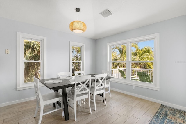 dining room with baseboards, visible vents, and light wood-style floors