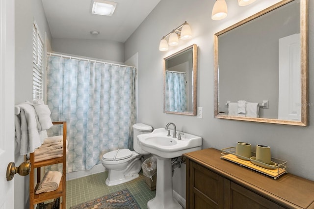 full bath with toilet and tile patterned flooring