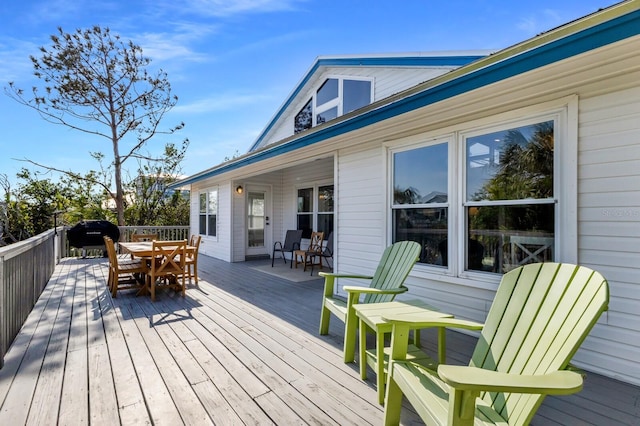 wooden deck featuring outdoor dining area