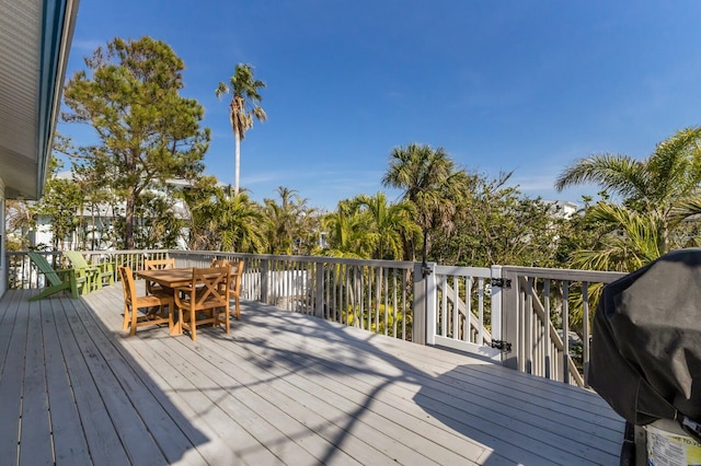 deck featuring grilling area and outdoor dining space