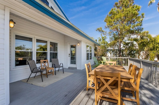 wooden terrace with outdoor dining area