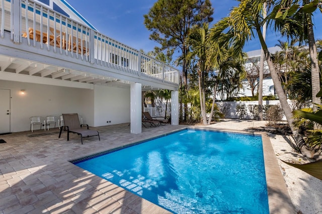 view of swimming pool with a patio area and fence