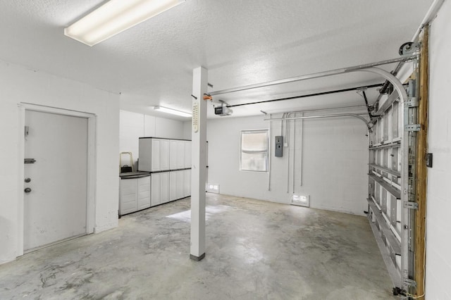 garage featuring a garage door opener and electric panel