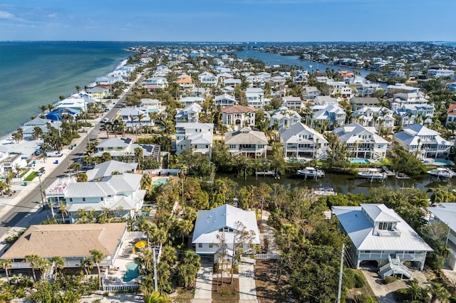 drone / aerial view featuring a water view and a residential view