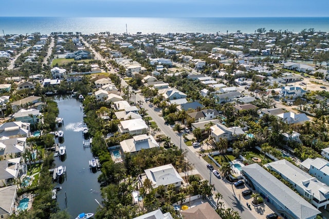 drone / aerial view featuring a water view and a residential view