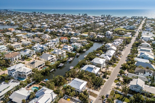 birds eye view of property with a water view and a residential view