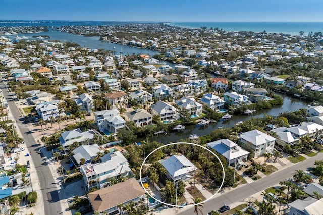 bird's eye view featuring a water view and a residential view