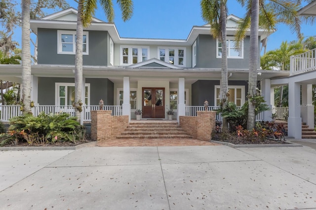 view of front of home with covered porch and french doors