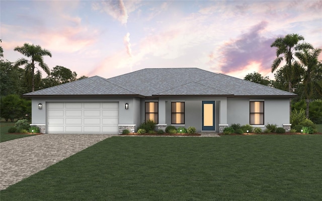 view of front of house with a front lawn, decorative driveway, an attached garage, and stucco siding