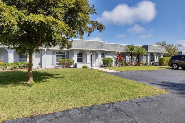 ranch-style home featuring a front yard