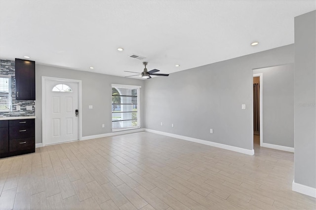 unfurnished living room with ceiling fan and light hardwood / wood-style flooring