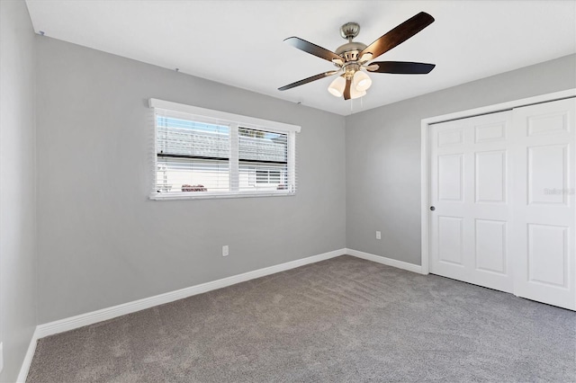 unfurnished bedroom featuring ceiling fan, carpet flooring, and a closet