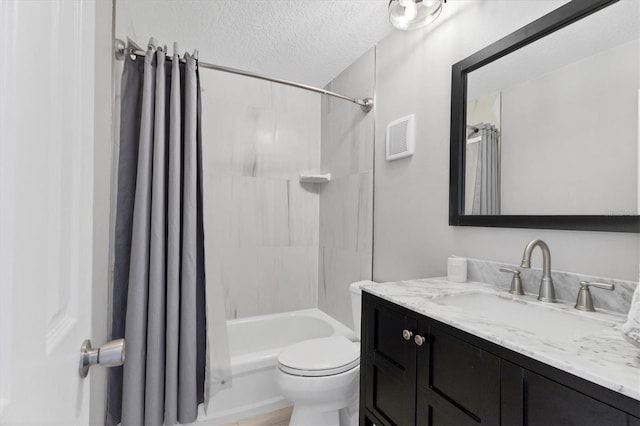 full bathroom with shower / tub combo with curtain, vanity, toilet, and a textured ceiling