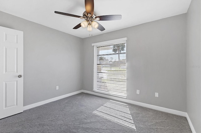 carpeted spare room with ceiling fan