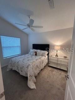 carpeted bedroom with vaulted ceiling and ceiling fan