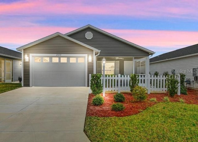 single story home with a garage and a lawn