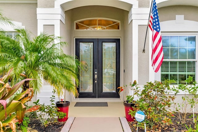 entrance to property with french doors and stucco siding