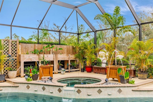 pool featuring glass enclosure, a patio, and an in ground hot tub