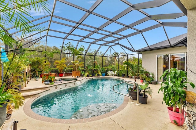 view of swimming pool featuring a pool with connected hot tub, a lanai, and a patio