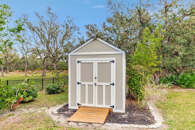 view of shed featuring fence