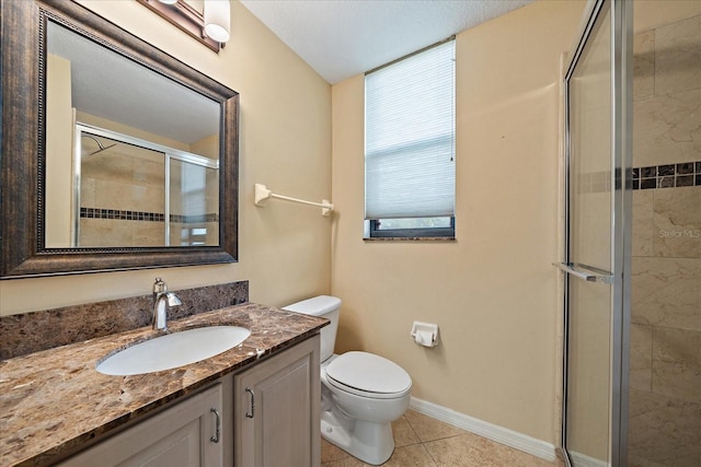 bathroom featuring baseboards, toilet, tile patterned flooring, vanity, and a shower stall