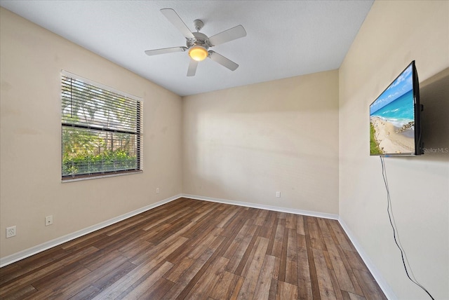 unfurnished room with ceiling fan, baseboards, and wood finished floors