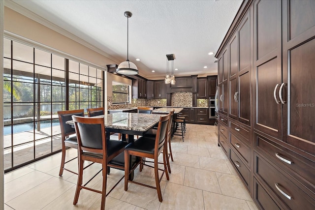 dining area featuring ornamental molding, a textured ceiling, and recessed lighting