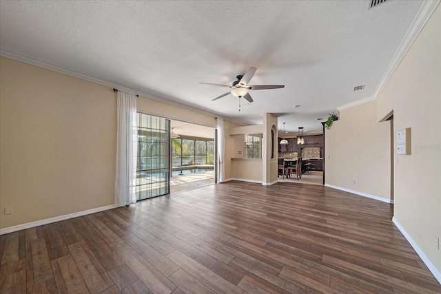 unfurnished living room with baseboards, a ceiling fan, dark wood-style flooring, crown molding, and a textured ceiling