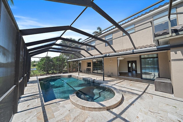 view of swimming pool featuring a lanai, ceiling fan, a pool with connected hot tub, and a patio