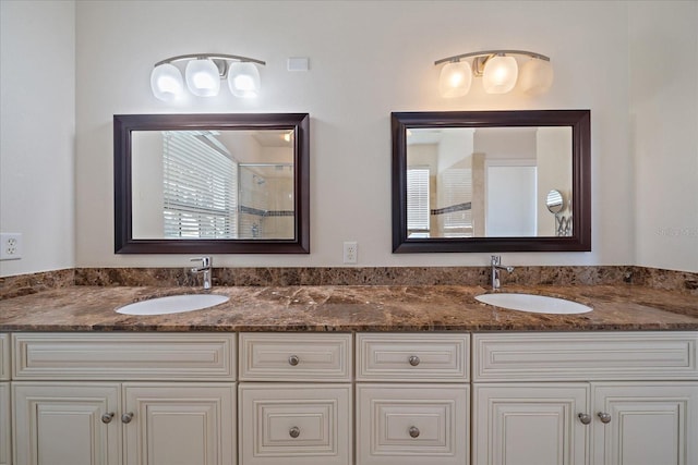 full bathroom with a sink and double vanity