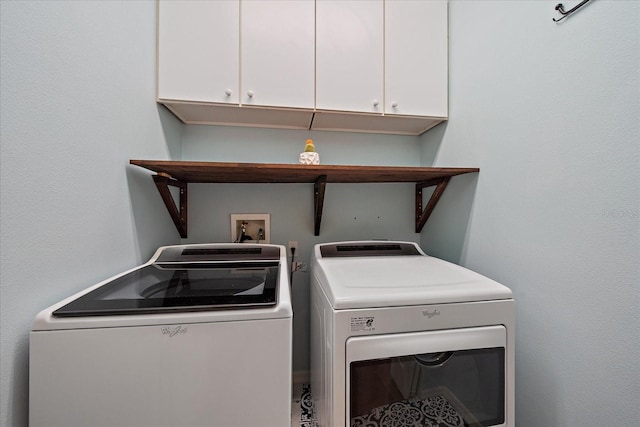 laundry room featuring independent washer and dryer and cabinet space