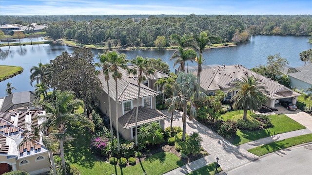 aerial view with a forest view and a water view