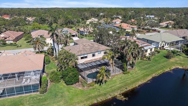 aerial view with a water view, a wooded view, and a residential view