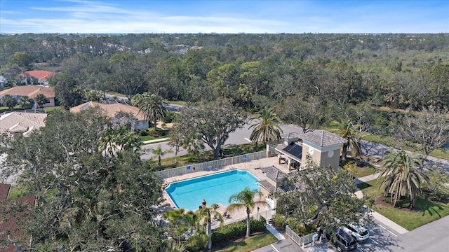 birds eye view of property featuring a view of trees