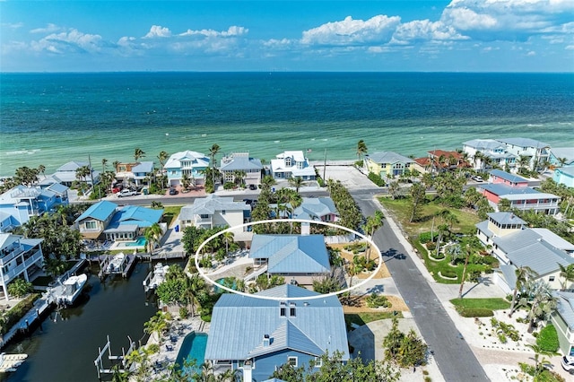 birds eye view of property with a water view and a residential view